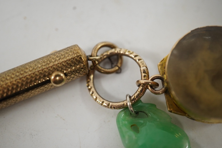 An unmarked yellow metal vinaigrette, 18mm, together with a yellow metal overlaid combination propelling pencil/penknife and a carved jade fob. Condition - fair to good.